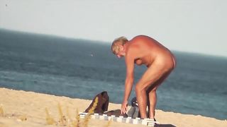 Парень на пляже подсматривает за обнаженными нудистами
